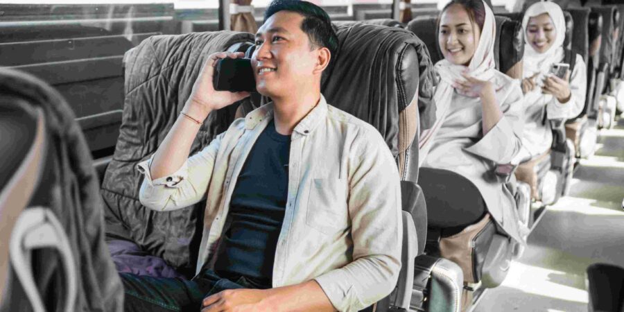 Discover Kuching: Top Attractions and Hidden Gems 1 Happy man sitting enjoying his trip using a bus