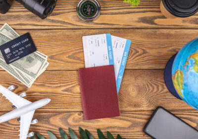 166590704-documents-plane-tickets-and-other-travel-supplies-on-a-wooden-background-top-view