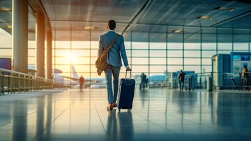 businessman-walking-with-luggage-airport-terminal-travel-conceptgenerative-ai_841229-9757